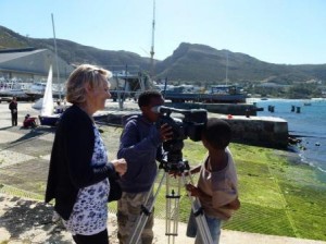 EIA Director Jennifer Lonsdale hands over her camera to students of Izivunguvungu Sailing Club